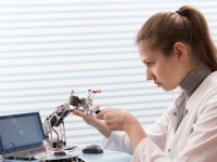 Girl Solder and adjust Electronic Device